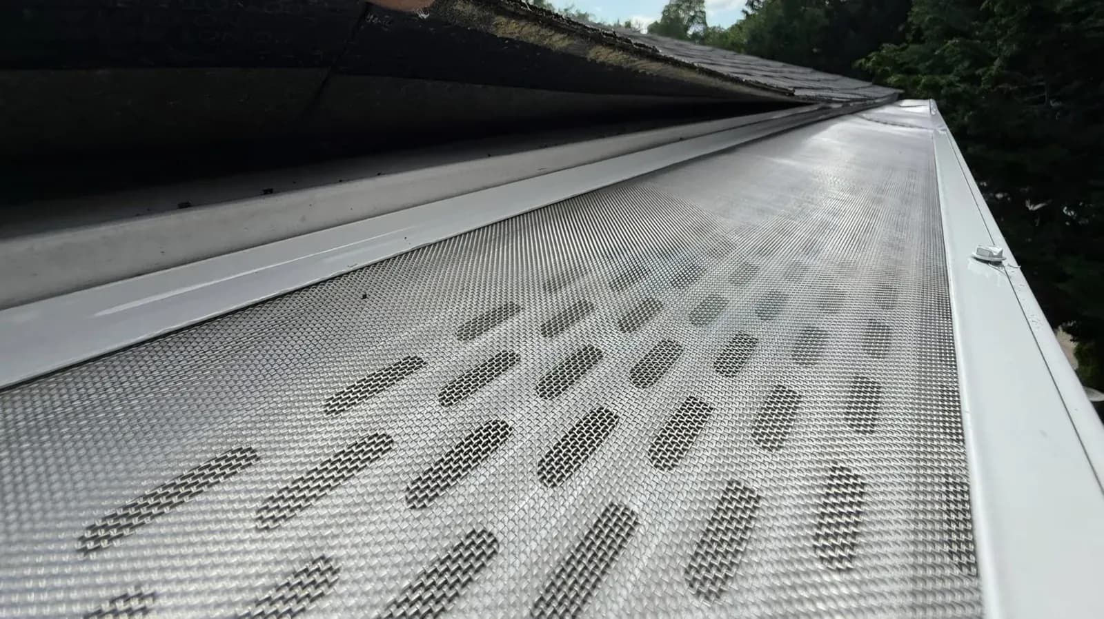 Close-up of a micro-mesh gutter guard installed over a seamless gutter by Haus Prime